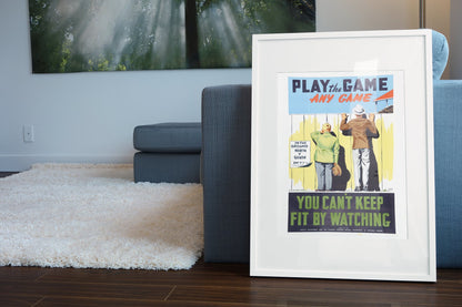 Play the Game — Any Game poster leaning beside a blue sofa