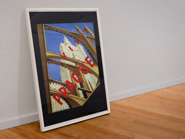 Praha Prague poster in a white frame leaning against a wall