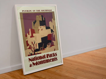 Pueblos of the Southwest National Parks poster in a white frame leaning against a wall