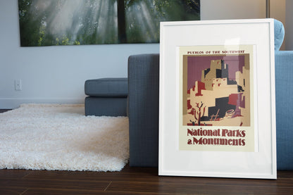 Pueblos of the Southwest National Parks poster leaning beside a blue sofa