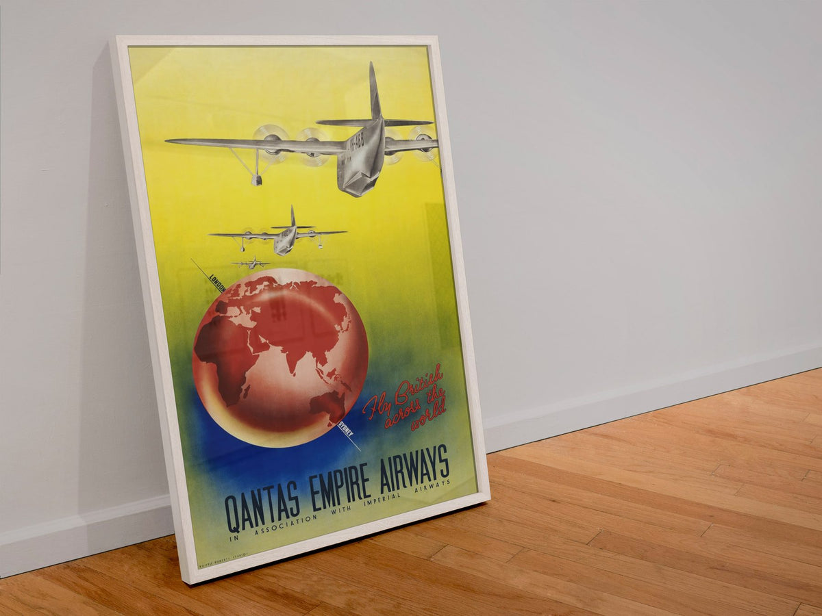 Qantas Empire Airways poster in a white frame leaning against a wall