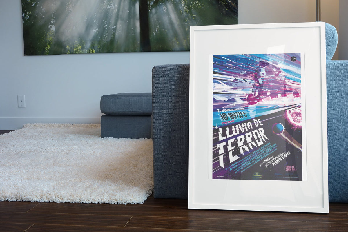 Rains of Terror, Lluvia de Terror Spanish edition poster in a white frame leaning beside a blue sofa