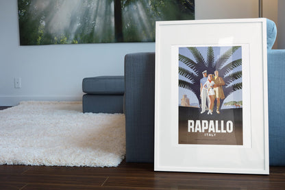 Rapallo Italy poster leaning beside a blue sofa