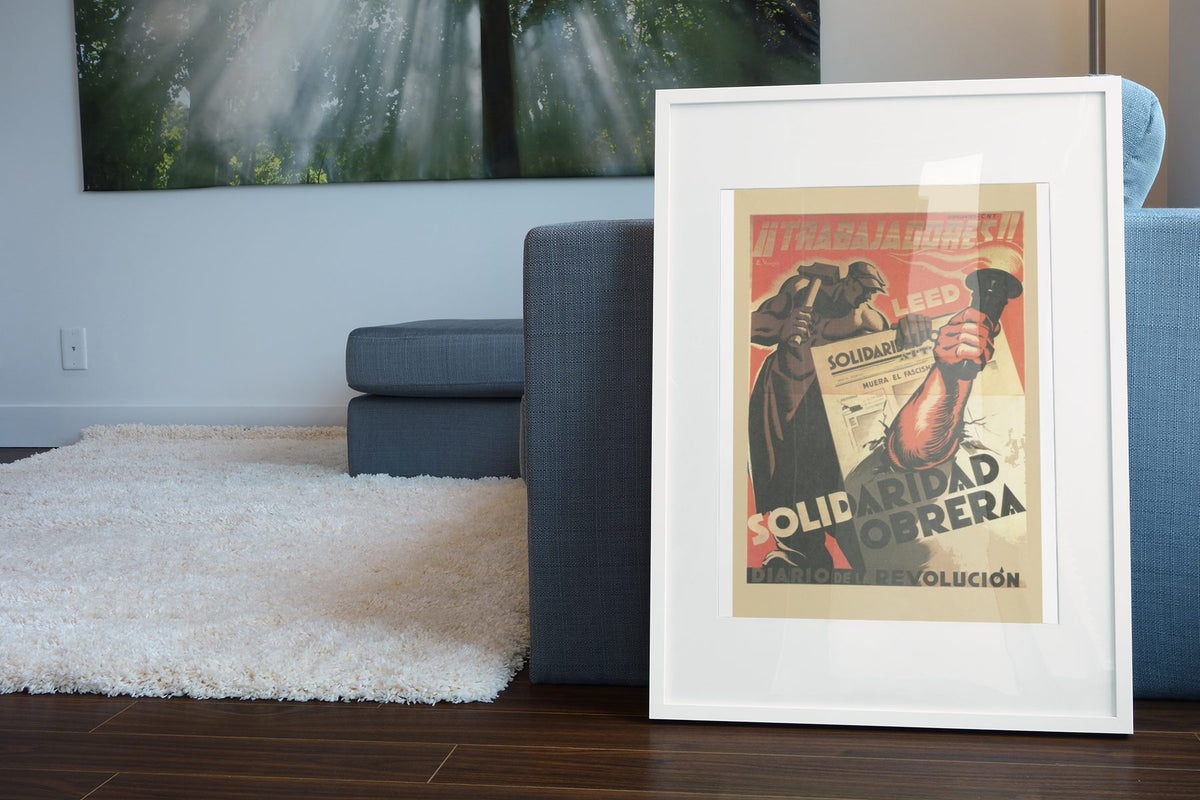 Read Solidaridad Obrera Workers Solidarity poster leaning beside a blue sofa