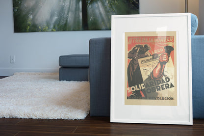 Read Solidaridad Obrera Workers Solidarity poster leaning beside a blue sofa