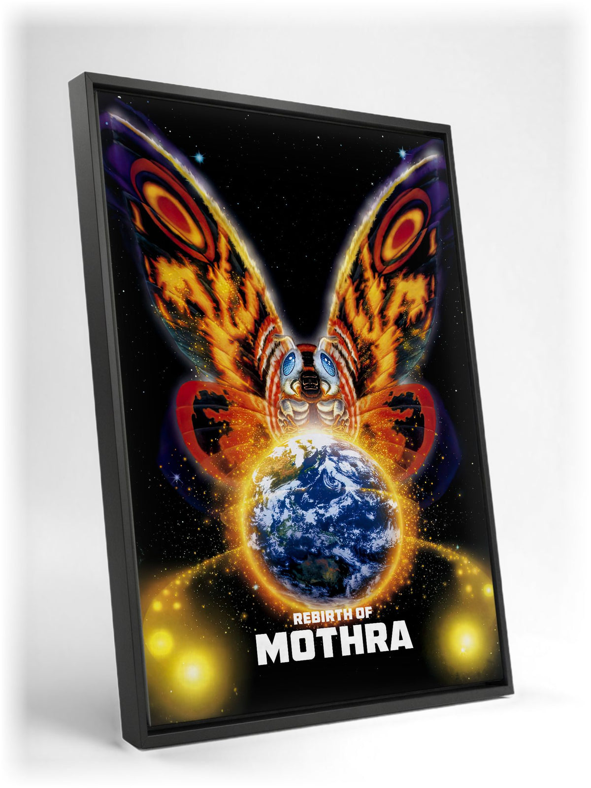 Rebirth of Mothra (1996) Movie Key Art as a black floater framed canvas leaning against a wall