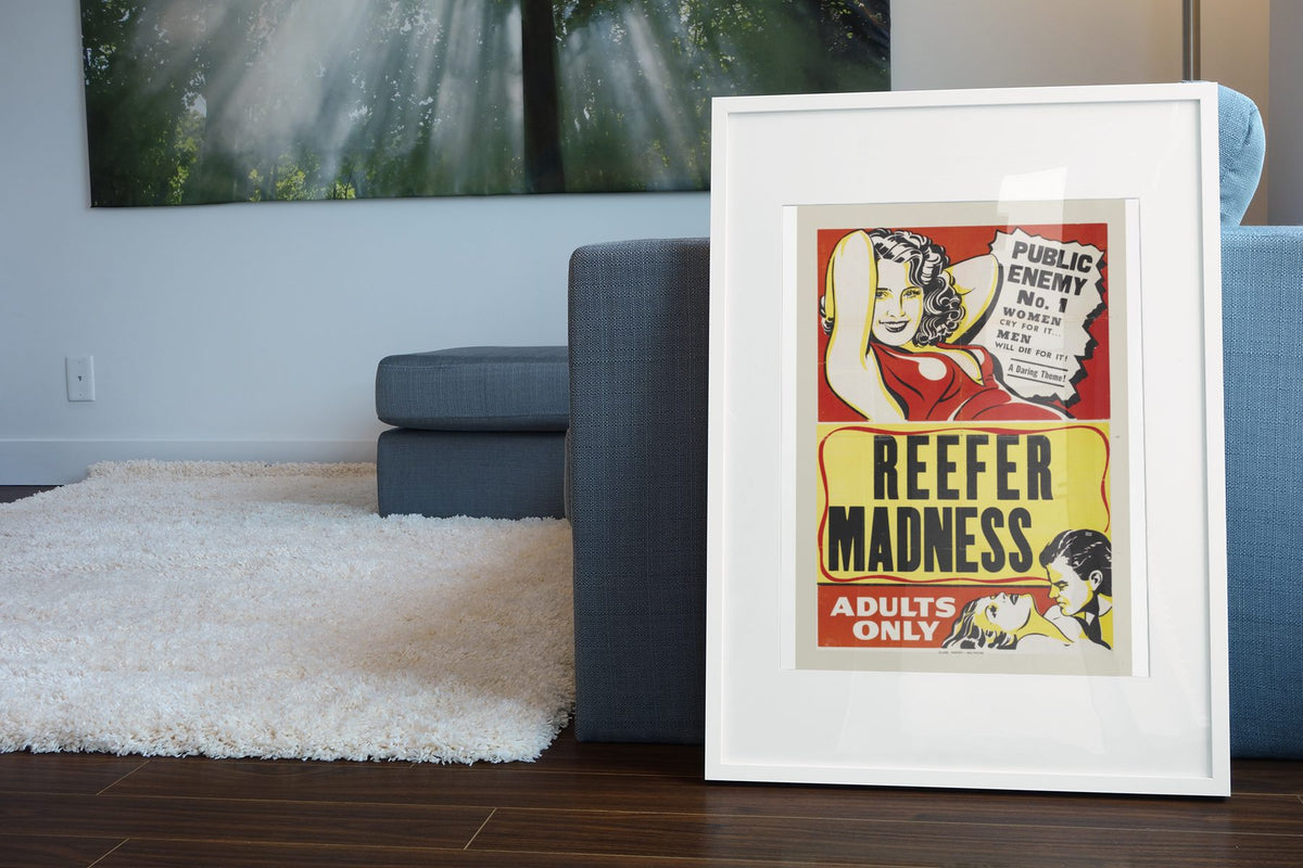 Reefer Madness Adults Only poster leaning beside a blue sofa