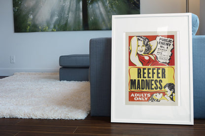 Reefer Madness Adults Only poster leaning beside a blue sofa