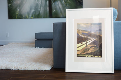 Reichsautobahnen in Deutschland poster leaning beside a blue sofa