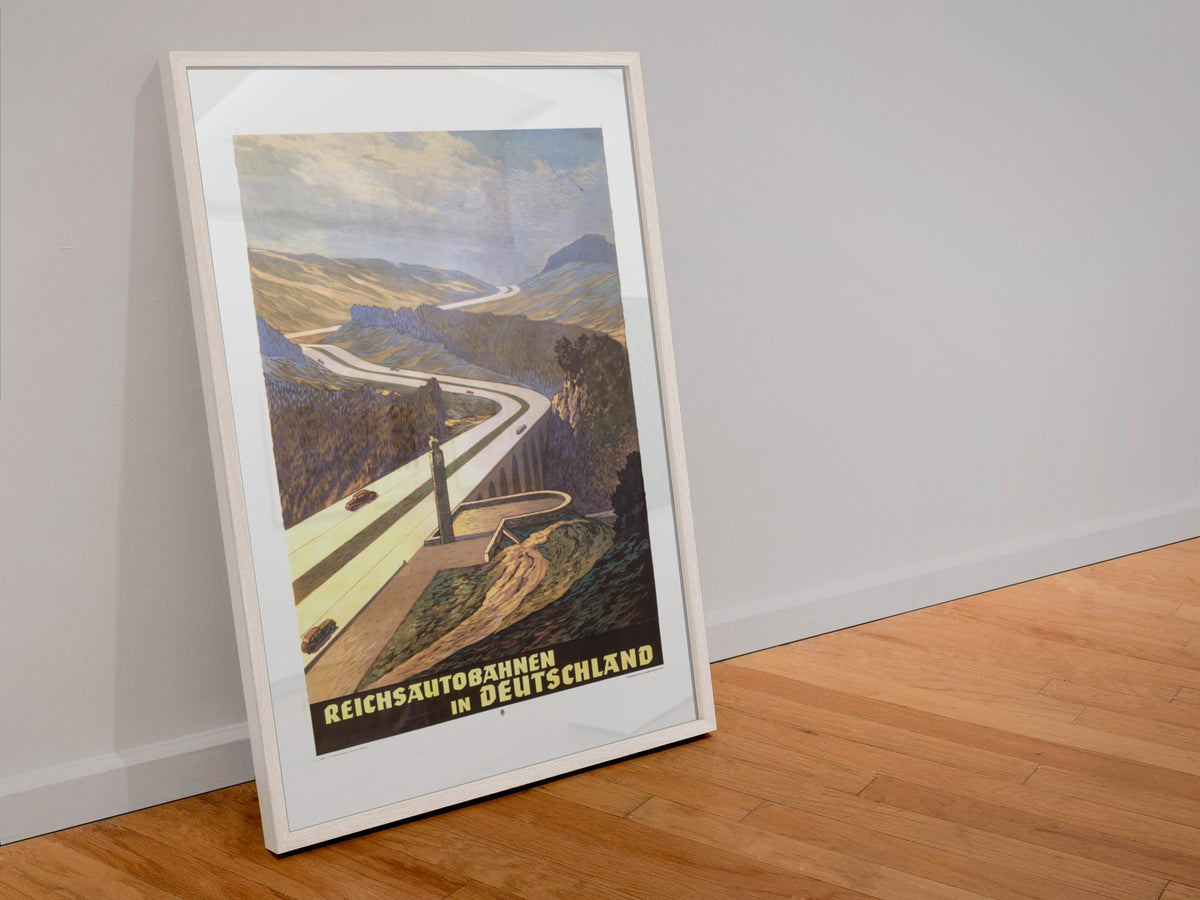 Reichsautobahnen Mountain Road poster in a white frame leaning against a wall