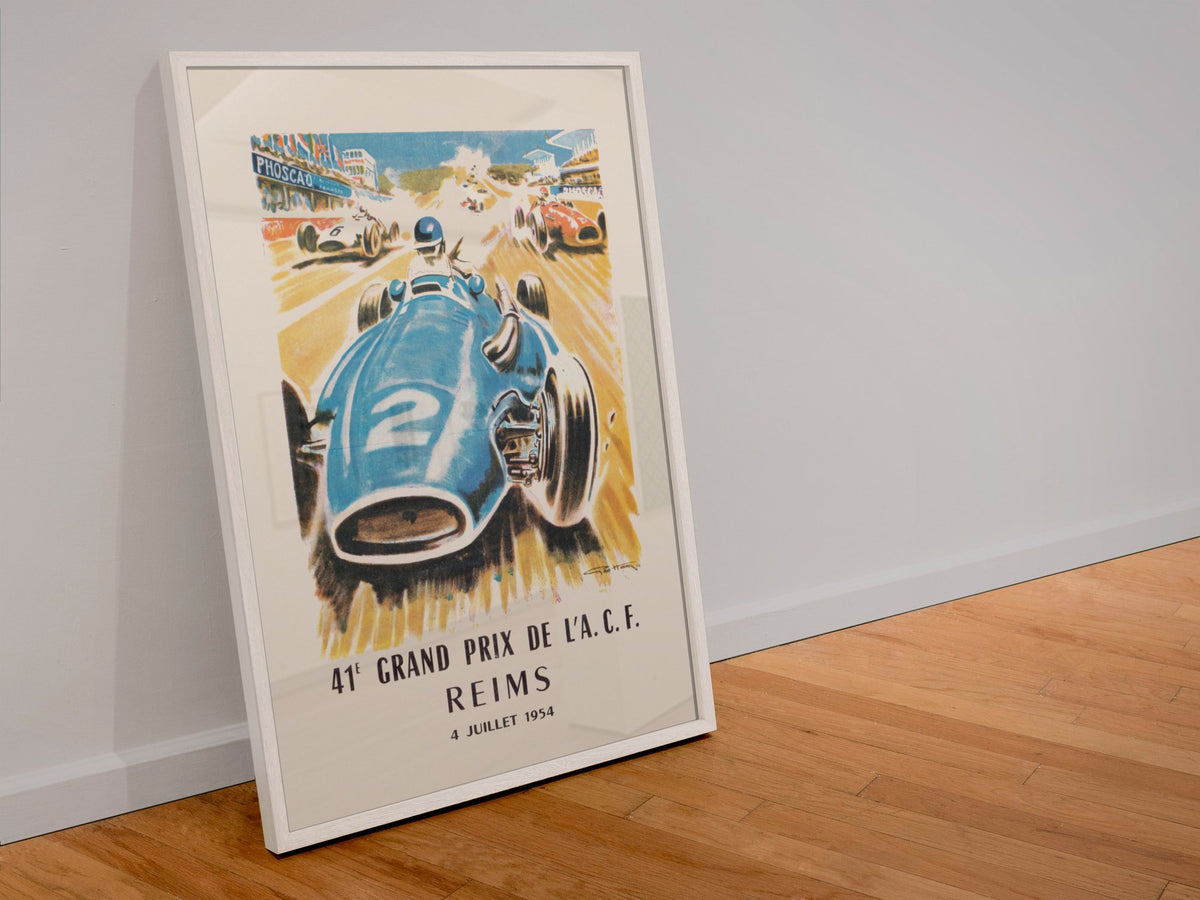 Grand Prix de l'ACF Reims 1954 poster in a white frame leaning against a wall