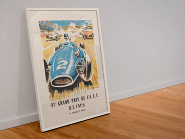 Grand Prix de l'ACF Reims 1954 poster in a white frame leaning against a wall