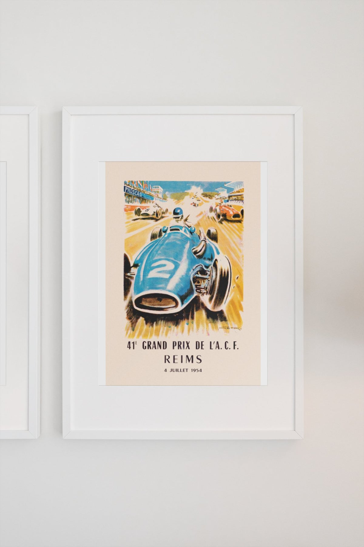 Grand Prix de l'ACF Reims 1954 poster in a white frame on a light wall