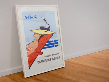 Relax Chargeurs Reunis poster in a white frame leaning against a wall
