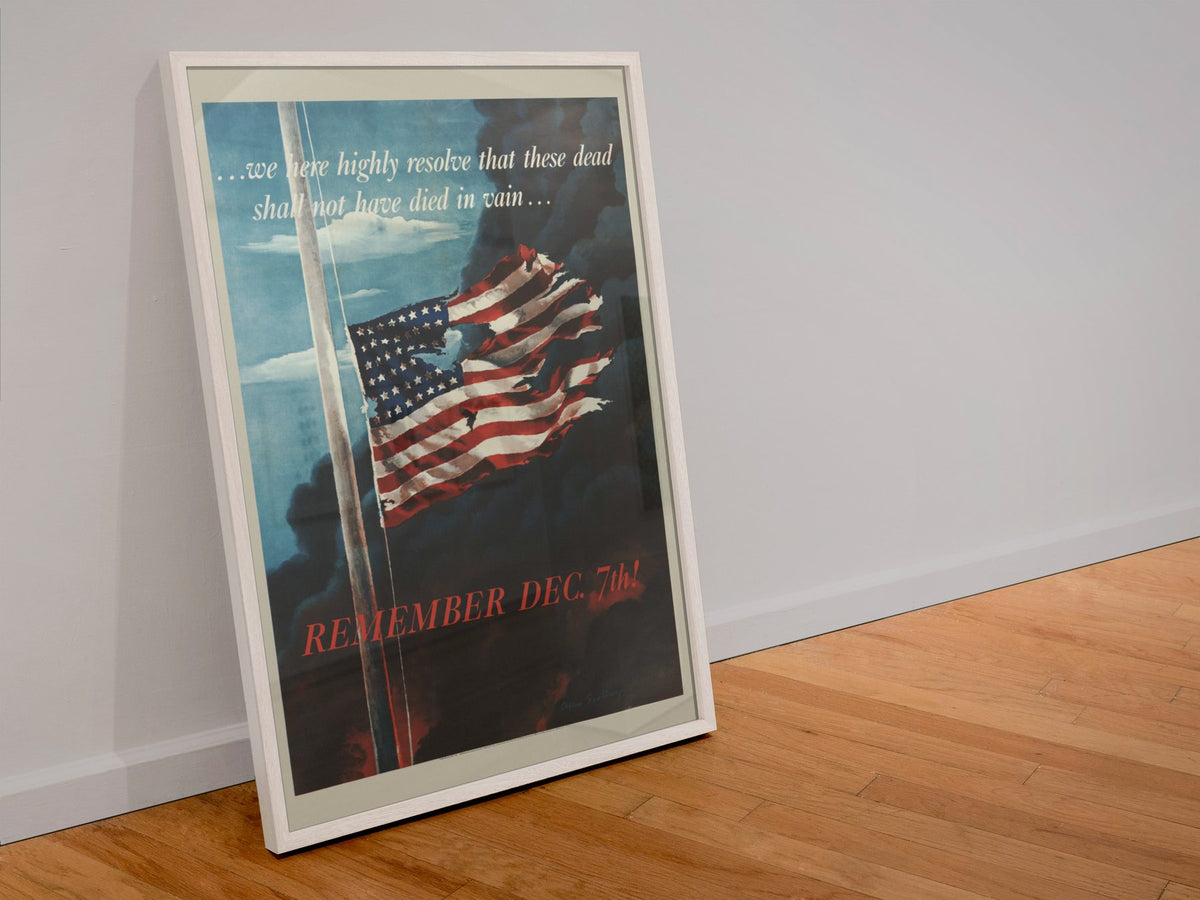 Remember Dec 7th poster in a white frame leaning against a wall