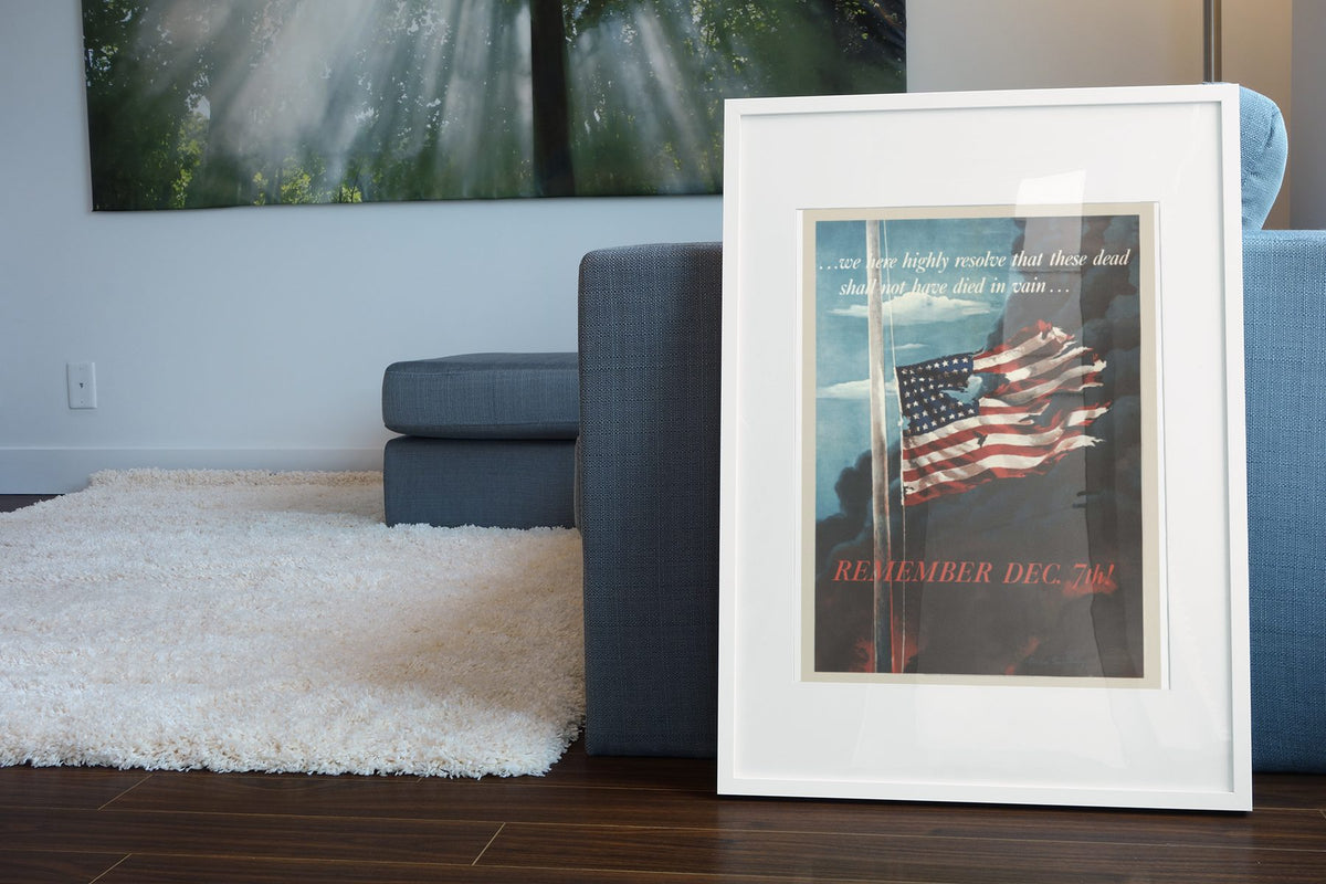 Remember Dec 7th poster leaning beside a blue sofa