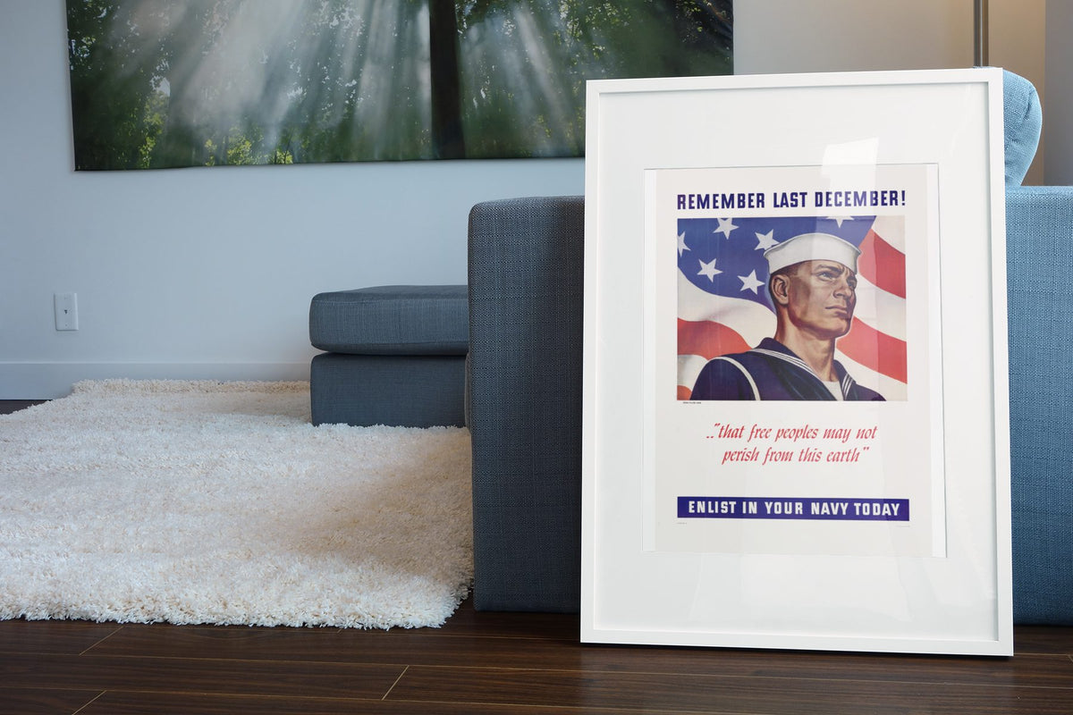 Remember Last December — Enlist in Your Navy poster leaning beside a blue sofa