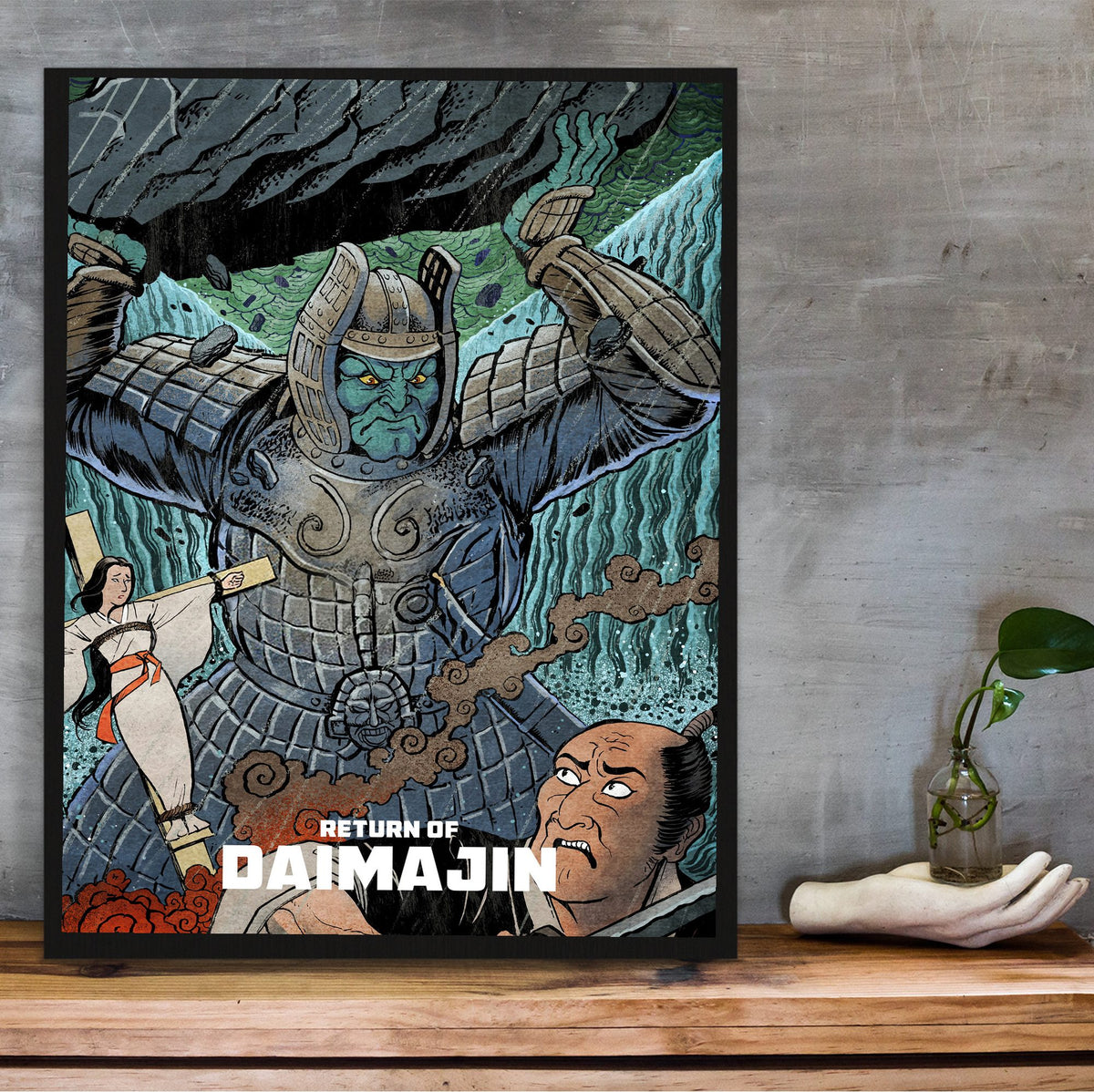 Return of Giant Majin (1966) Movie Illustrated Art poster in a black frame on a wooden shelf against concrete