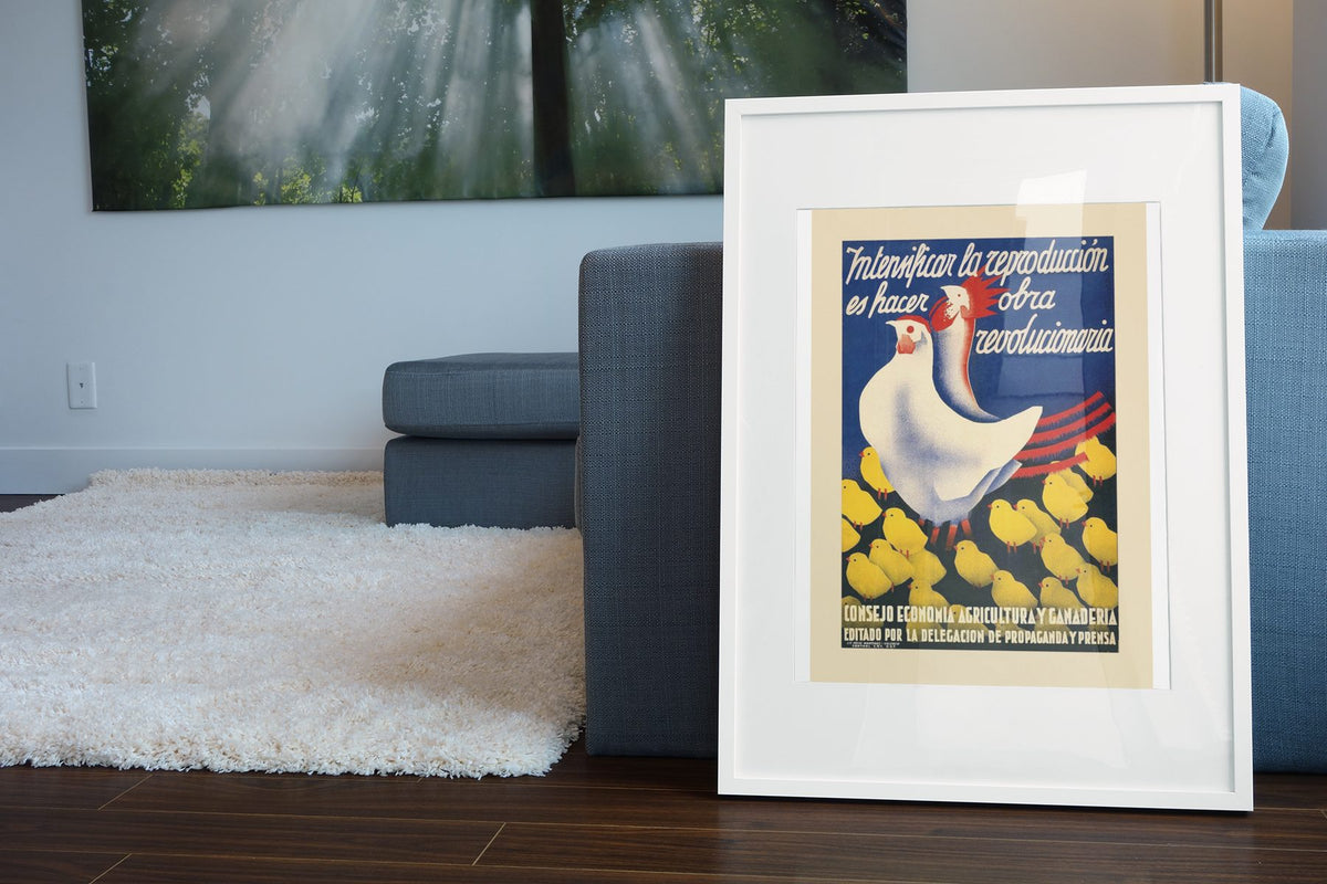 Revolutionary Work — Hen and Chicks poster leaning beside a blue sofa