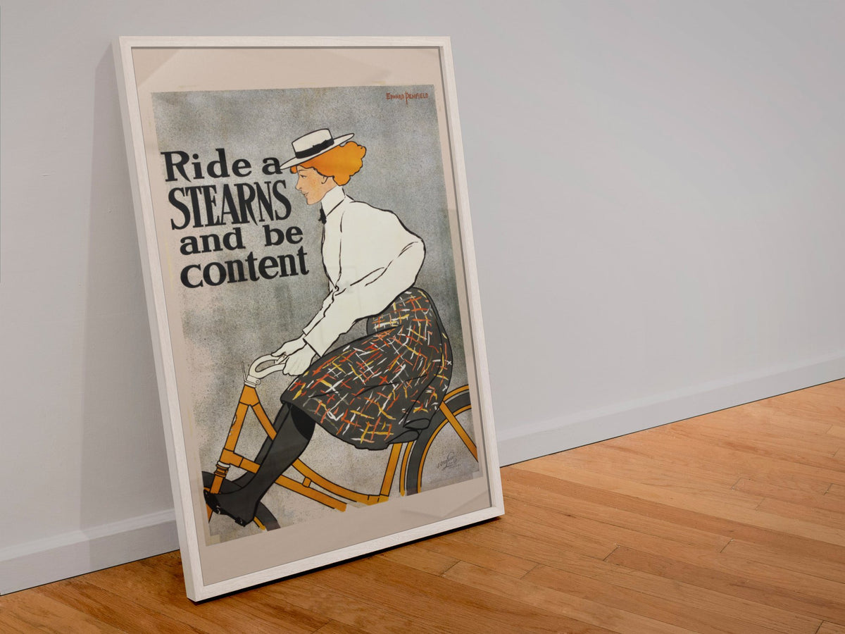 Ride a Stearns and Be Content poster in a white frame leaning against a wall