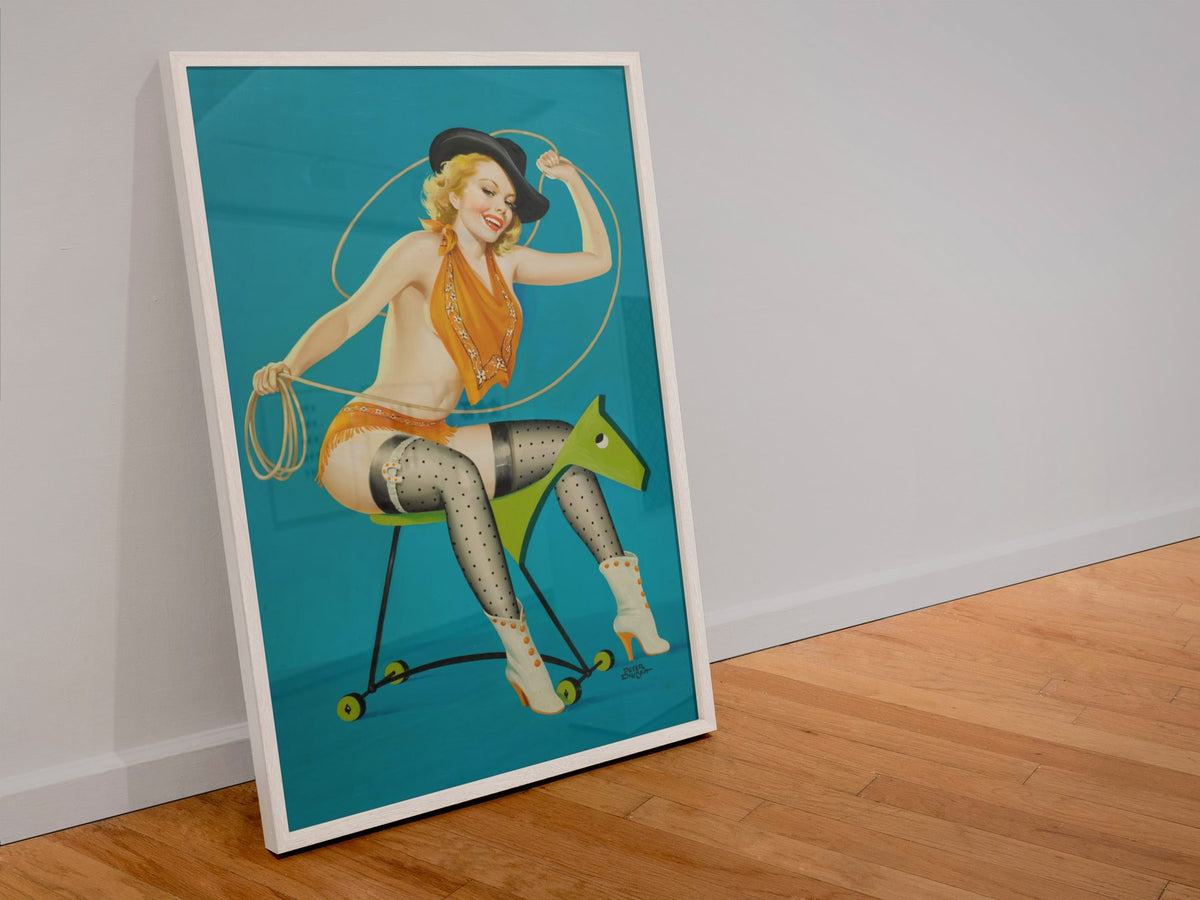 Ride Em Cowgirl poster in a white frame leaning against a wall
