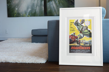 Road Racers 1959 poster in a white frame leaning beside a blue sofa