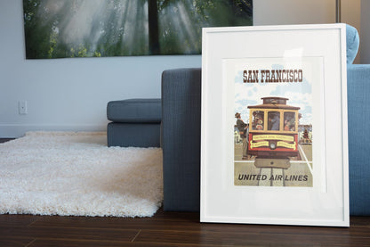 San Francisco Cable Car United poster leaning beside a blue sofa