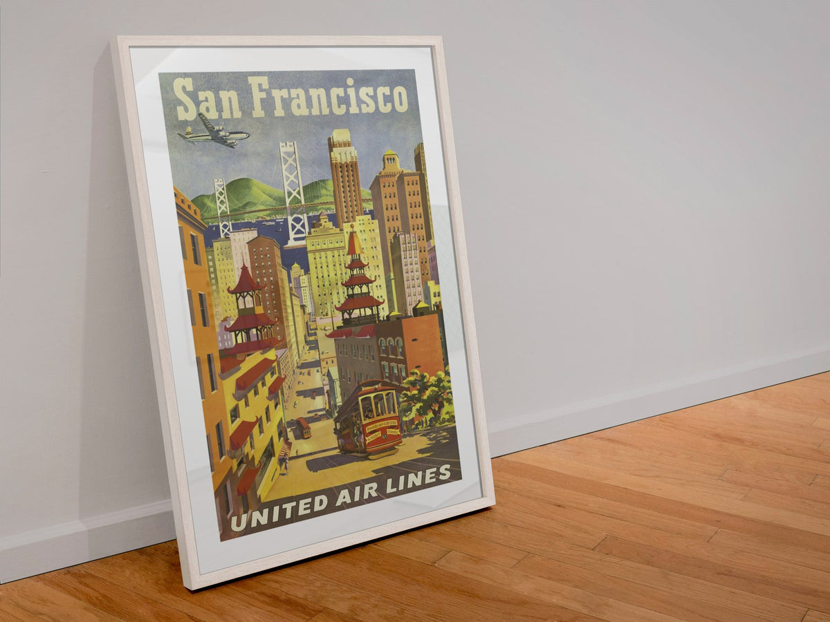 San Francisco United Air Lines 1950s poster in a white frame leaning against a wall