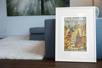 San Francisco United Air Lines 1950s poster leaning beside a blue sofa