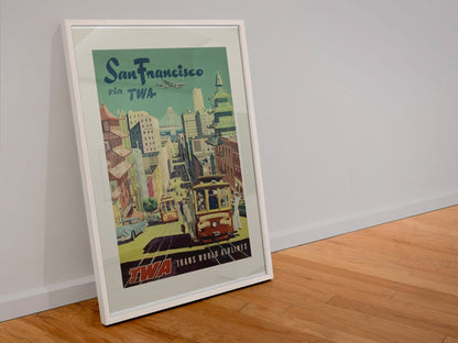 San Francisco Fly TWA Cable Car poster in a white frame leaning against a wall