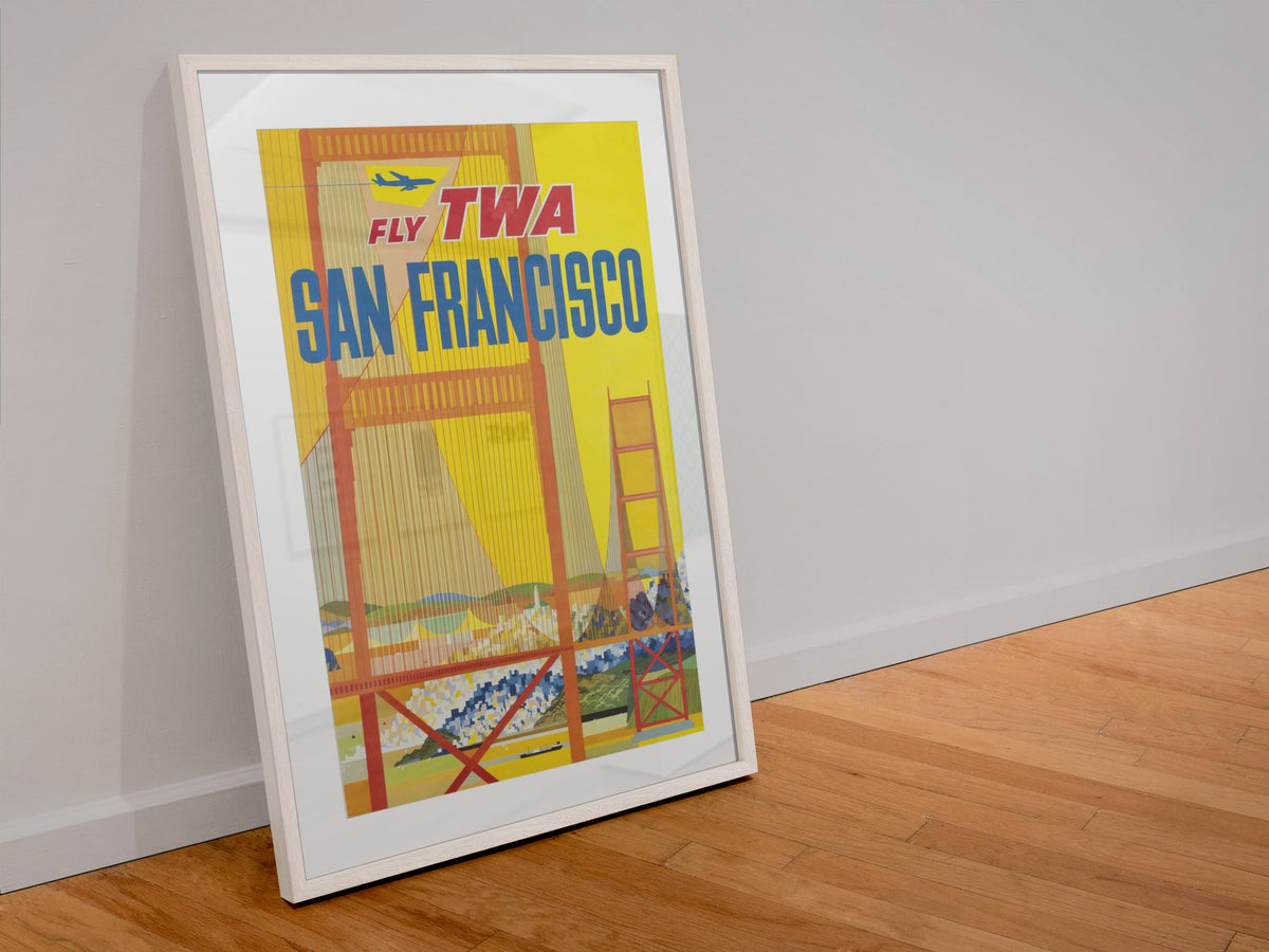 San Francisco Fly TWA 1958 poster in a white frame leaning against a wall