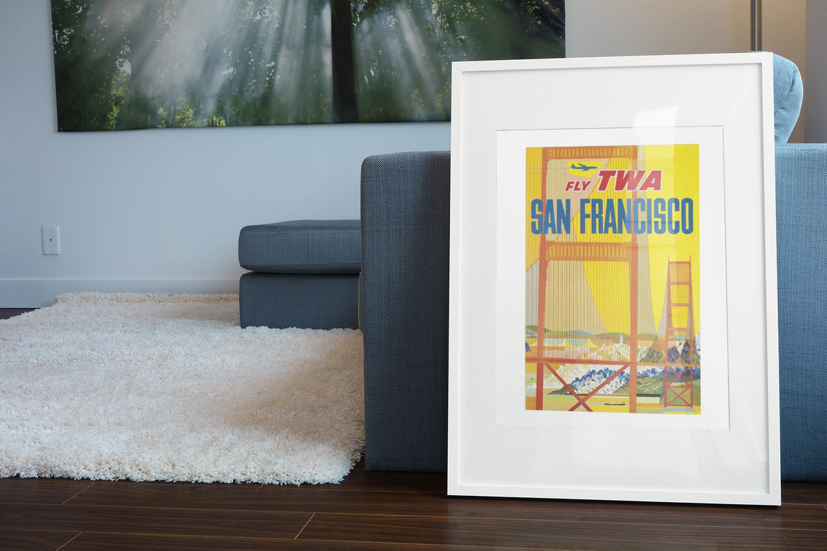 San Francisco Fly TWA 1958 poster leaning beside a blue sofa