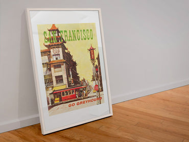 San Francisco Go Greyhound poster in a white frame leaning against a wall
