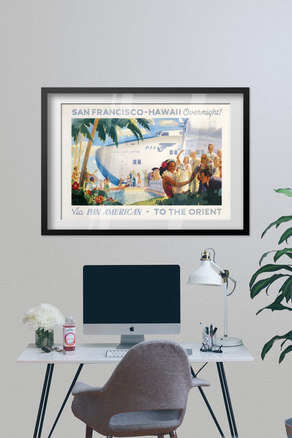 San Francisco to Hawaii Pan American poster framed on a grey wall above a desk