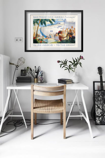 San Francisco to Hawaii Pan American poster framed above a desk in a bright white room