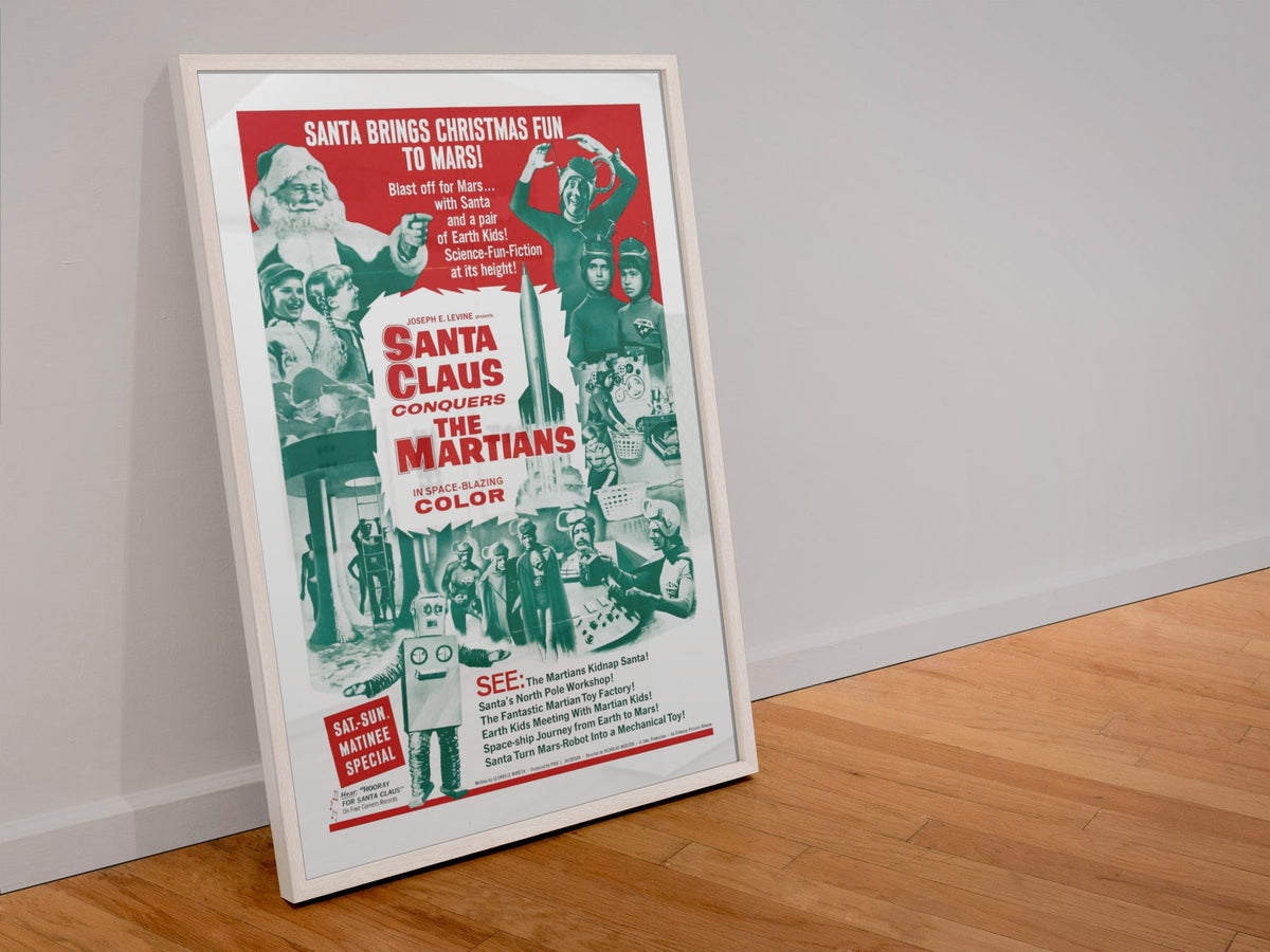 Santa Claus Conquers the Martians poster in a white frame leaning against a wall