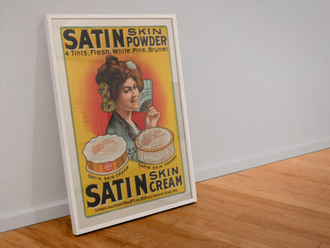 Satin Skin Powder poster in a white frame leaning against a wall