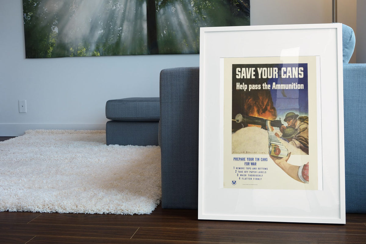 Save Your Cans — Help Pass the Ammunition poster leaning beside a blue sofa