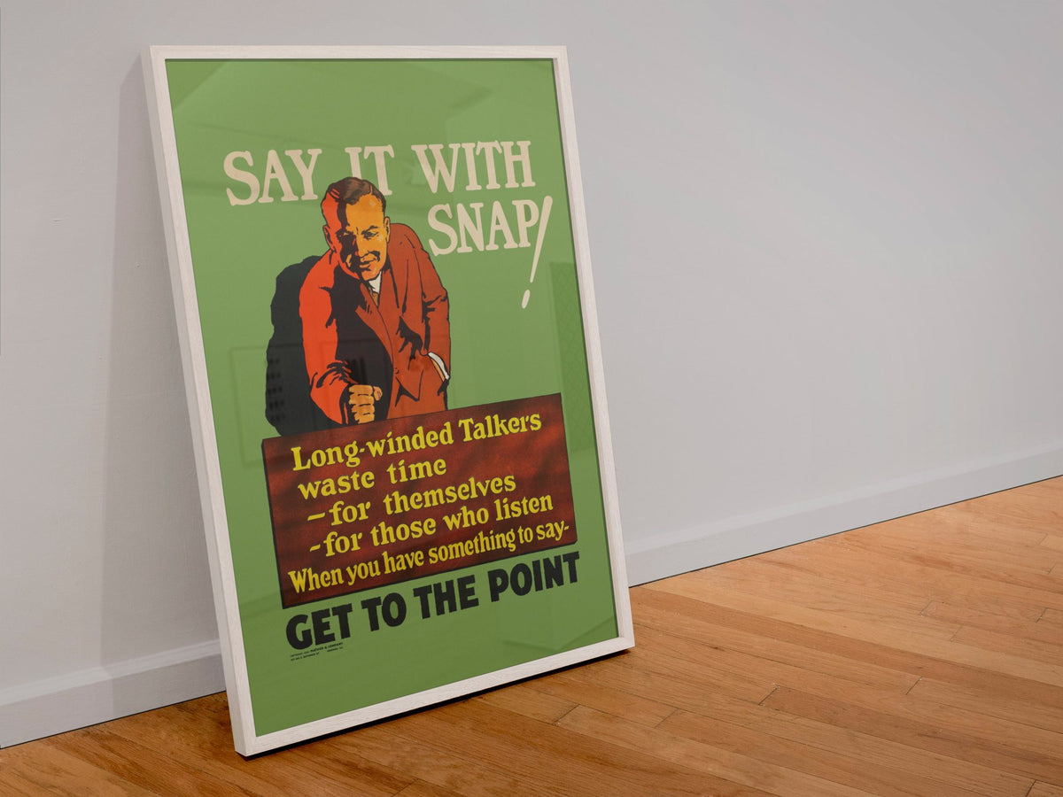 Say It With Snap poster in a white frame leaning against a wall