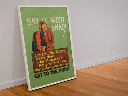 Say It With Snap poster in a white frame leaning against a wall