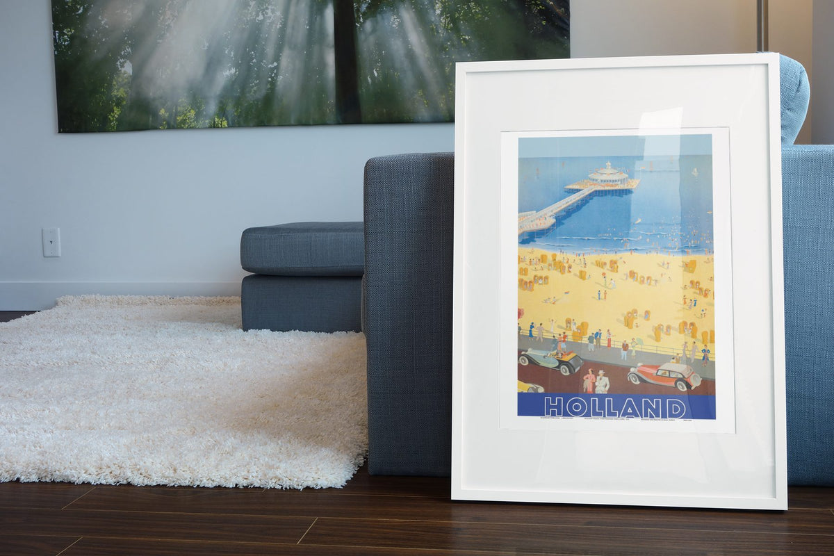 Scheveningen Holland poster leaning beside a blue sofa