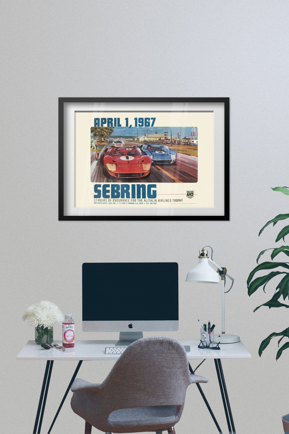 Sebring 12 Hours 1967 poster framed above a desk with a computer