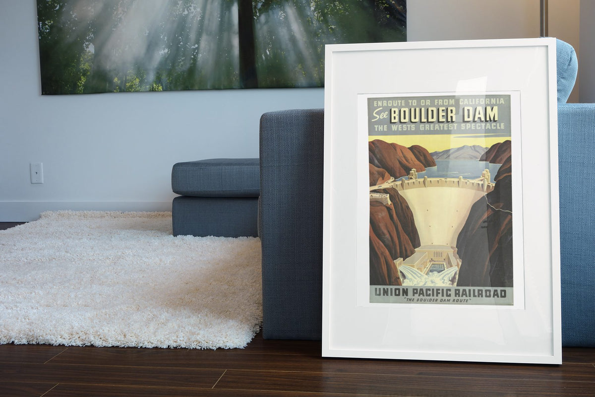See Boulder Dam Union Pacific poster leaning beside a blue sofa