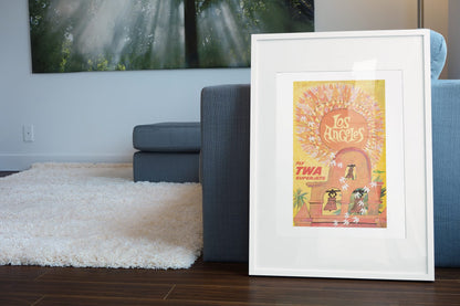 See Los Angeles TWA poster leaning beside a blue sofa