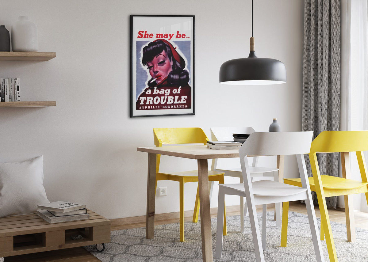 She May Be a Bag of Trouble poster framed above a dining table