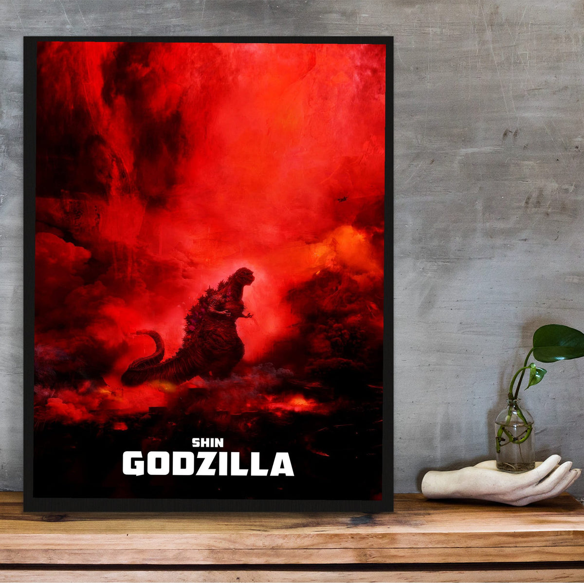 Shin Godzilla (2016) Movie Key Art poster in a black frame on a wooden shelf against concrete
