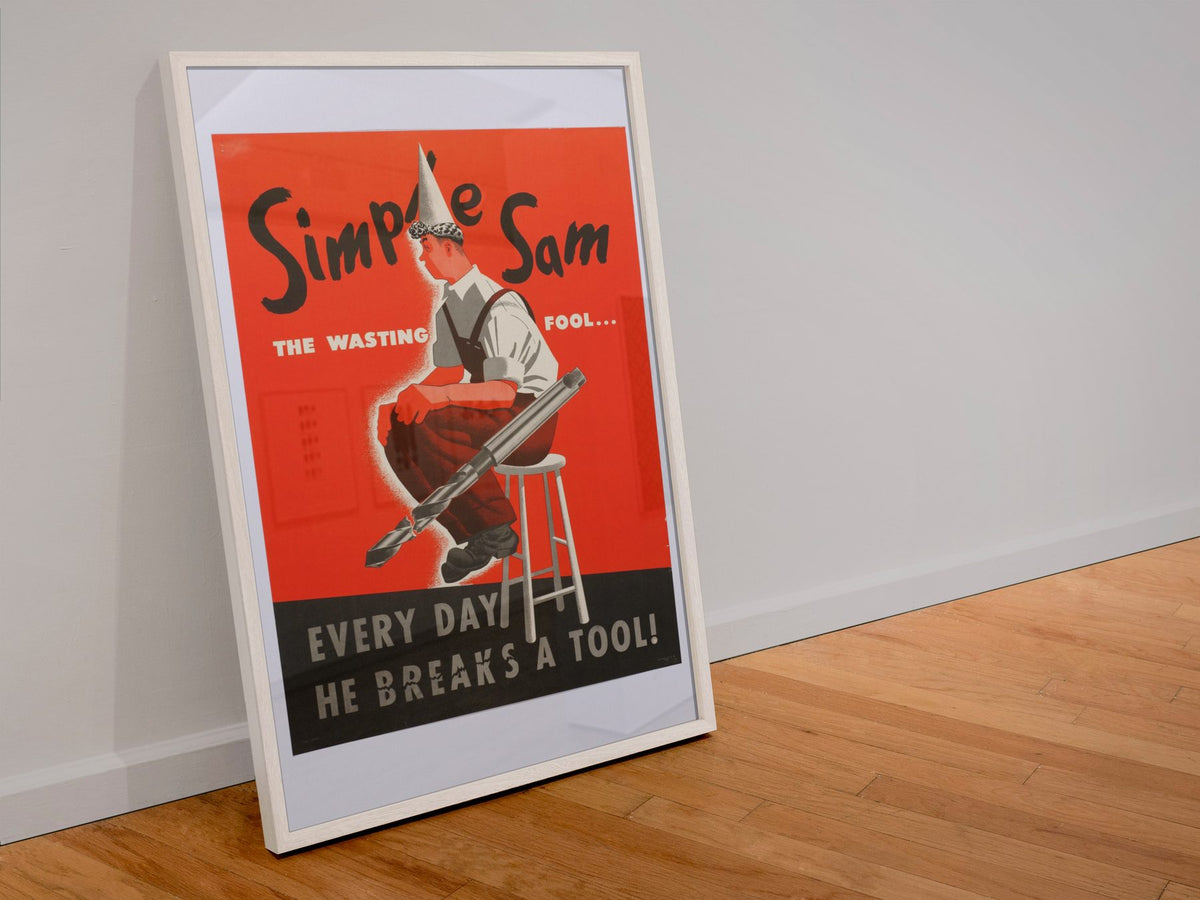Simple Sam the Wasting Fool poster in a white frame leaning against a wall