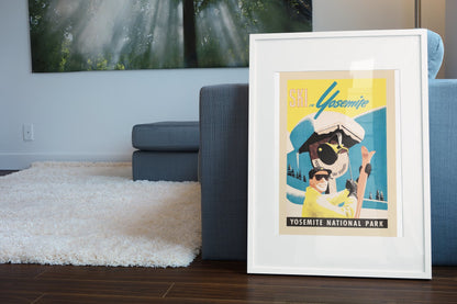 Ski in Yosemite poster leaning beside a blue sofa