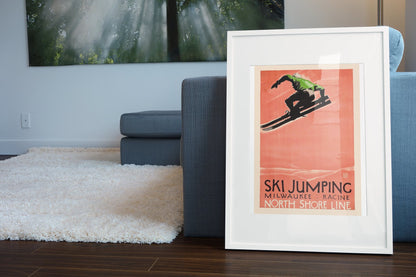 Ski Jumping North Shore Line poster leaning beside a blue sofa