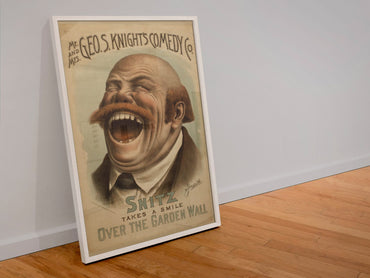 Snitz Takes a Smile poster in a white frame leaning against a wall